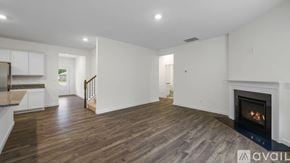 Cleveland house for rent - A spacious living room with a fireplace and hardwood floors.