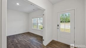 Cleveland house for rent - A room with a white door and a window with a view of a building and trees outside.