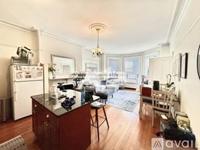 Boston apartment for rent - A kitchen with a black countertop and a white refrigerator.