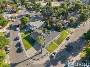 Sacramento house for rent - A bird's eye view of a residential area with houses, cars, and trees.