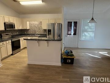 Springfield house for rent - A kitchen with white cabinets and a black and white patterned backsplash.