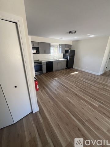 Wyandotte apartment for rent - A kitchen with a black fridge and wooden floors.