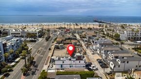 Huntington Beach condo for rent - A red marker is placed on a building in the middle of a beachfront town.