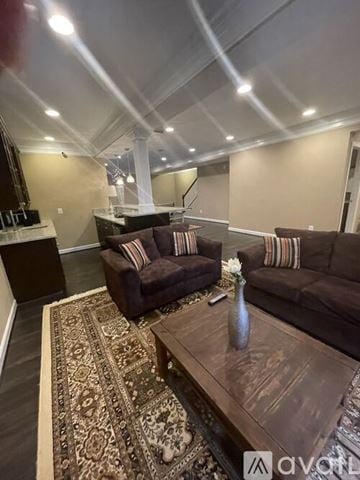 Aldie house for rent - A living room with a brown couch and a coffee table.