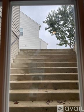Aldie house for rent - A set of stairs leading up to a building with a tree in the background.