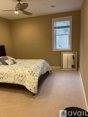 Aldie house for rent - A bedroom with a bed, a window, and a ceiling fan.