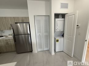 Miami apartment for rent - A kitchen with a stainless steel refrigerator and a white refrigerator freezer.