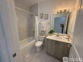 Miami apartment for rent - A bathroom with a toilet, sink, and bathtub.