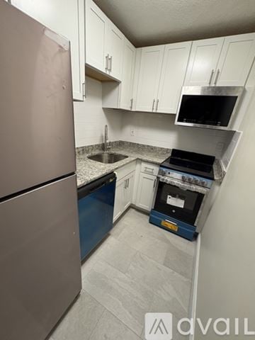 Boston apartment for rent - A kitchen with a refrigerator, oven, and microwave.