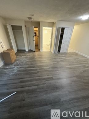 Boston apartment for rent - A room with wooden flooring and a cardboard box on the floor.