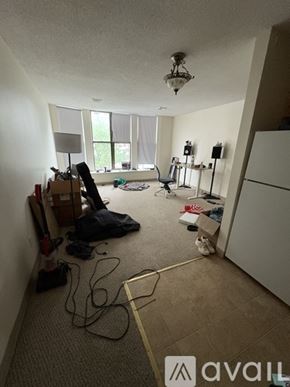 Boston apartment for rent - A room with a lot of clutter and a chandelier hanging from the ceiling.