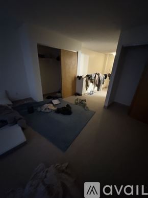 Boston apartment for rent - A room with a blue mat and clothes hanging on a line.