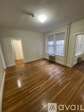 Boston apartment for rent - A room with wooden floors and white walls.