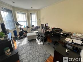 Boston apartment for rent - A home office with a desk, chair, and exercise equipment.