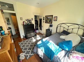 Boston apartment for rent - A bedroom with a bed, dresser, and mirror.