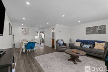 Newport condo for rent - A living room with a grey couch and a coffee table.