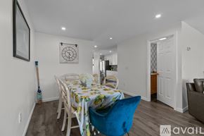 Newport condo for rent - A dining room with a table set for two and a blue chair.