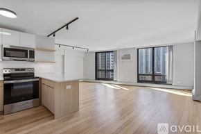 Chicago apartment for rent - A kitchen with wooden floors and a stainless steel oven.