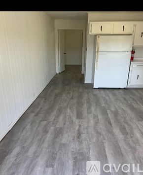 Morristown apartment for rent - A kitchen area with a white fridge and cabinets.