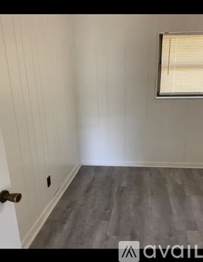 Morristown apartment for rent - A room with a wooden floor and a window with blinds.
