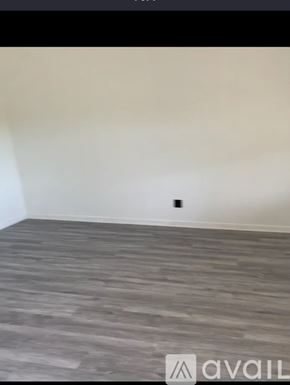 Morristown apartment for rent - A room with a wooden floor and a wall socket.