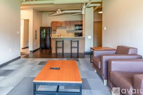 Whitewater apartment for rent - A modern living room with a kitchen in the background.