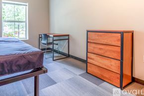 Whitewater apartment for rent - A bedroom with a bed, desk, and dresser.