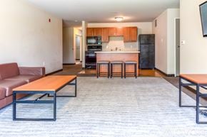 Whitewater apartment for rent - A living room with a couch, a table, and a television.