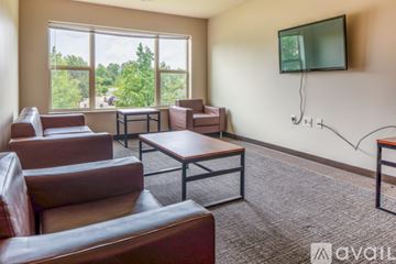Whitewater apartment for rent - A living room with brown leather furniture and a flat screen TV mounted on the wall.