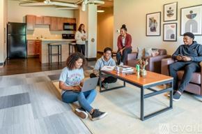 Whitewater apartment for rent - A living room with a grey carpet and brown furniture.