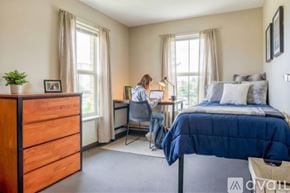 Whitewater apartment for rent - A kitchen with wooden cabinets and a black refrigerator.