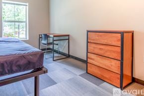 Whitewater apartment for rent - A bedroom with a bed, desk, and chair.