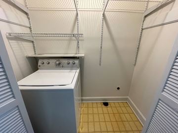 Wilson apartment for rent - A small, white, built-in dishwasher is in a narrow kitchen.
