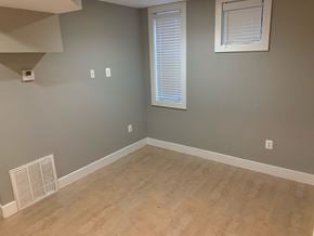 Washington apartment for rent - A room with a window and a wall-mounted air vent.