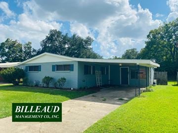 Lafayette house for rent - A house with a green lawn and a sign that says "Billeaud Management Co., Inc."