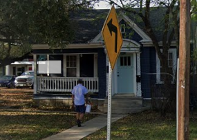San Antonio house for rent - A yellow sign with a black arrow pointing to the left is in front of a house.
