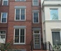 Washington apartment for rent - A red brick building with white windows and a black railing.