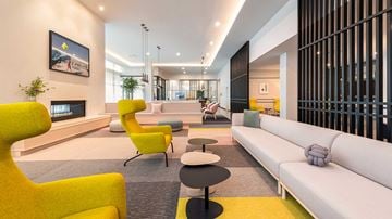 Oak Park apartment for rent - A modern living room with a yellow chair and a white sofa.