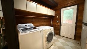 Sitka house for rent - A washer and dryer in a small laundry room.