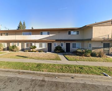 Downey apartment for rent - Apartment complex with a clear blue sky above.