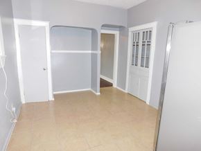 New Orleans apartment for rent - A room with a white door, a white wall, and a brown floor.