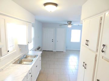Hammond apartment for rent - A kitchen with white cabinets and a tile floor.
