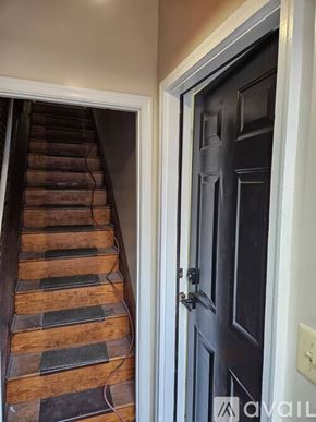 Baltimore townhouse for rent - A set of stairs leading up to a black door.