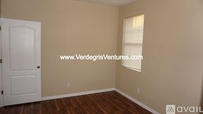 Fort Worth house for rent - A room with a white door and a window with blinds.