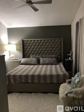 San Antonio apartment for rent - A bedroom with a large bed and a ceiling fan.