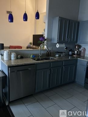 San Antonio apartment for rent - A kitchen with a white stove top oven and a white microwave above it.