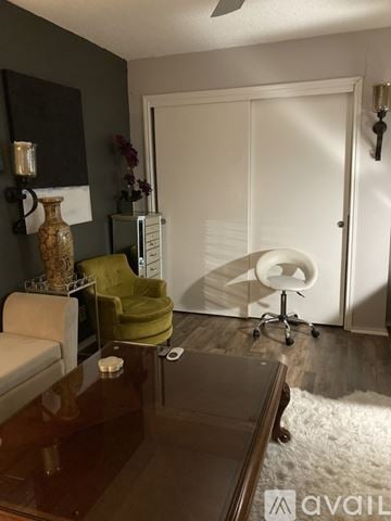 San Antonio apartment for rent - A living room with a brown table and a green chair.