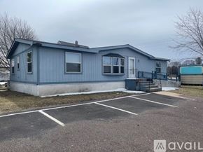 Houghton apartment for rent - A blue house with a parking lot in front.
