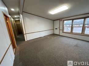 Houghton apartment for rent - A room with a carpeted floor, a door, and a window with a view of the outside.