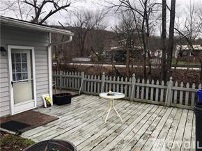 Lemont Furnace house for rent - A small white table is on a wooden deck.